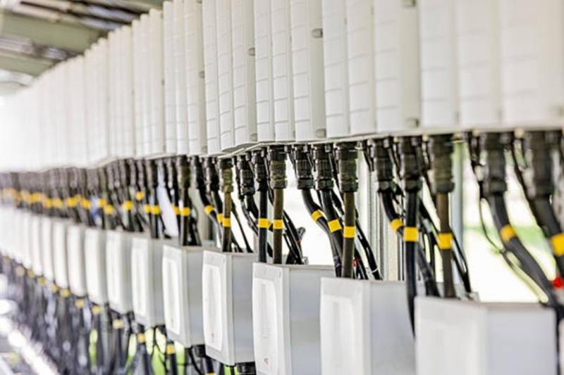 A row of inverters with their cabling